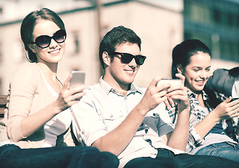 Image showing students looking at smartphones and tablet pc