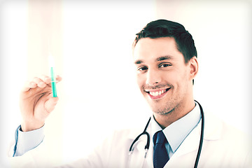 Image showing male doctor holding syringe with injection