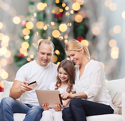 Image showing happy family with tablet pc and credit card