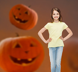 Image showing smiling girl over pumpkins background