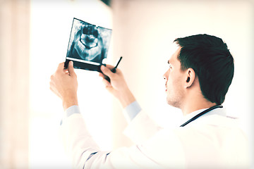 Image showing male doctor or dentist looking at x-ray