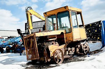 Image showing Old tractor among new equipment. Tyumen. Russia