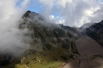 Image showing Ski slope in autumn and a cloud