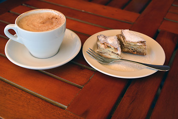 Image showing A cup of black coffee with baklava