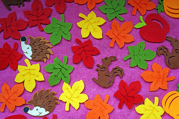 Image showing Hedgehog, squirrel and leaves out of felt on a pink fabric as a 