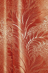 Image showing Texture of red and beige satin patterned curtains with folds