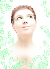 Image showing hi-key redhead with green eyes in water with flowers