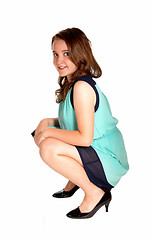 Image showing Teen girl crouching on floor.