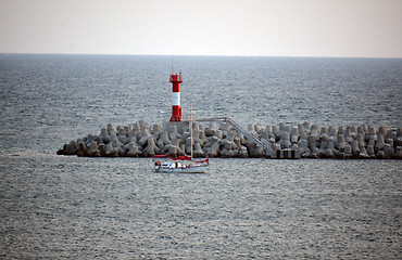 Image showing a lighthouse and a small yacht