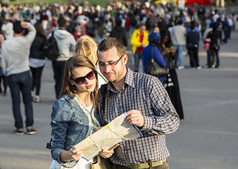 Image showing Couple with a Map in a Crowded City