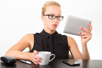 Image showing Business woman working on tablet PC.