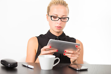 Image showing Business woman working on tablet PC.