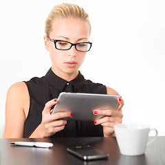 Image showing Business woman working on tablet PC.