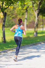 Image showing Young girl runner on the street.