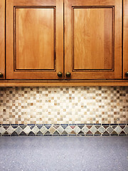 Image showing Kitchen with wooden cabinets and tile decor