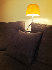 Image showing Cozy orange lamp and comfortable sofa