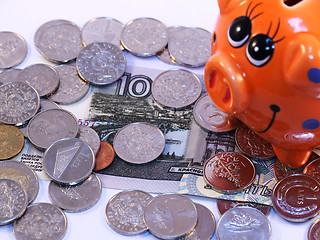 Image showing Bunch of coins and piggy bank