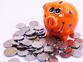 Image showing Bunch of coins and piggy bank