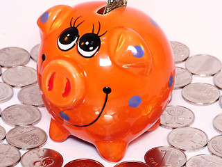 Image showing Bunch of coins and piggy bank