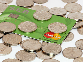 Image showing Bunch of coins with credit card