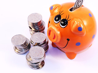 Image showing Bunch of coins and piggy bank