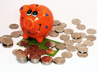 Image showing Bunch of coins and piggy bank