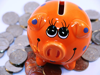 Image showing Bunch of coins and piggy bank