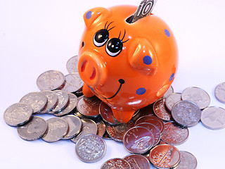 Image showing Bunch of coins and piggy bank