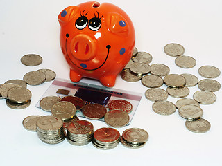 Image showing Bunch of coins and piggy bank