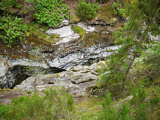 Image showing River deep in mountain forest.