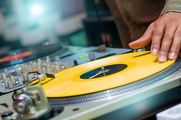 Image showing DJ playing vinyl on turntable