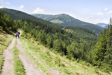 Image showing Happy hikers in mountains