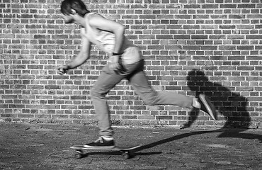 Image showing Skateboarder at speed through the city