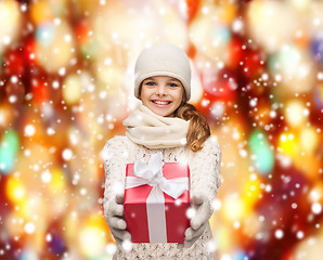 Image showing girl in hat, muffler and gloves with gift box