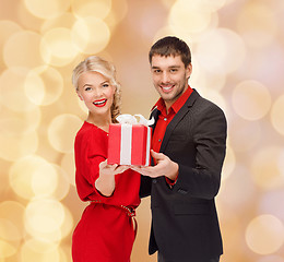 Image showing smiling man and woman with present