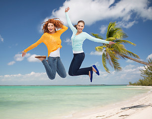 Image showing smiling young women jumping in air