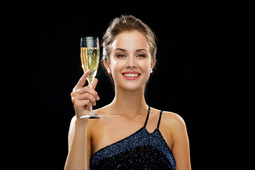 Image showing smiling woman holding glass of sparkling wine