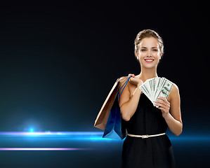 Image showing smiling woman in dress with shopping bags