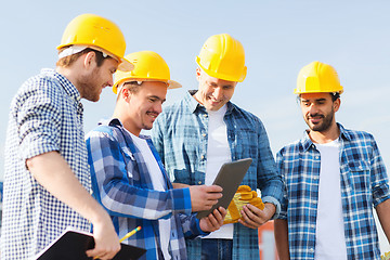 Image showing group of smiling builders with tablet pc outdoors