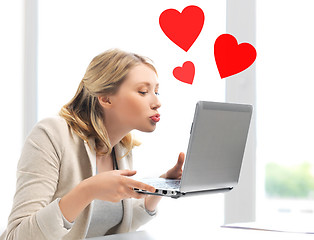 Image showing woman sending kisses with laptop computer