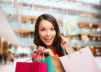 Image showing smiling woman with colorful shopping bags