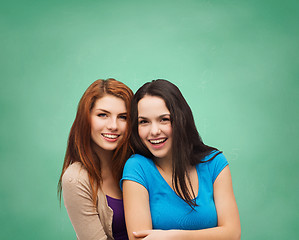 Image showing smiling teenage girls hugging