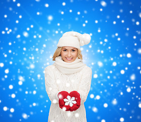 Image showing smiling woman in winter clothes with snowflake