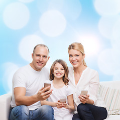 Image showing happy family with smartphones