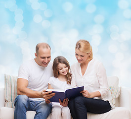 Image showing happy family with book at home