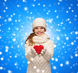 Image showing dreaming girl in winter clothes with red heart