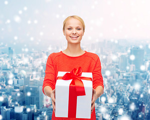 Image showing smiling woman in red clothes with gift box