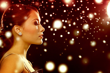 Image showing woman in evening dress wearing diamond earrings