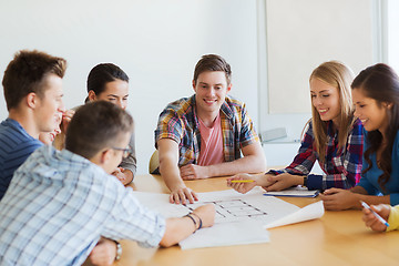 Image showing group of smiling students with blueprint