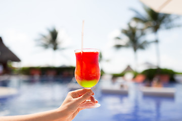 Image showing close-up of hand holding glass with cocktail